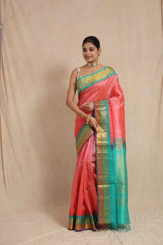 Front view of coral pink Kanchipuram Handloom SICO saree with aqua green woven border