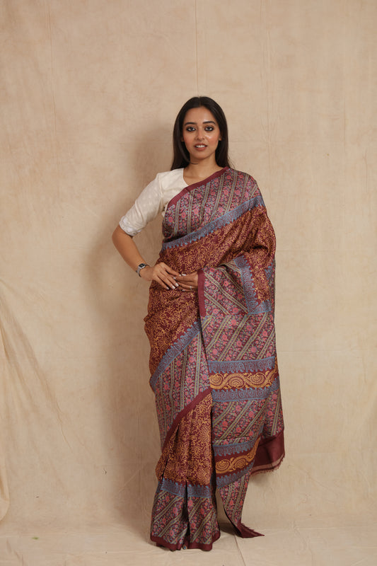 Front view of rust maroon printed Tussar silk saree with floral and paisley motifs