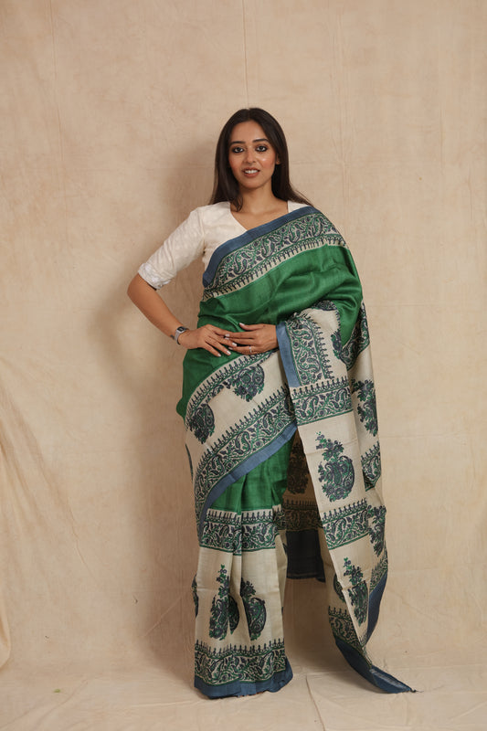 Front view of emerald green printed Tussar silk saree with ivory paisley pallu