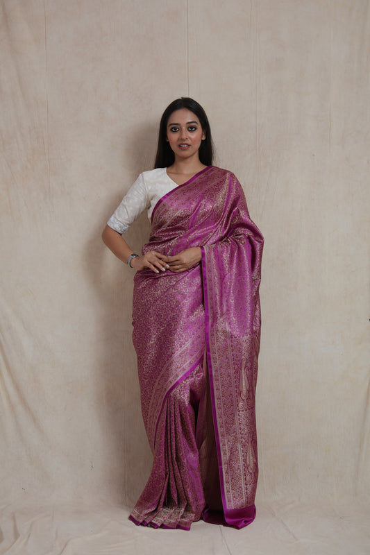 Model wearing radiant magenta Banarasi silk saree with antique gold woven floral motifs