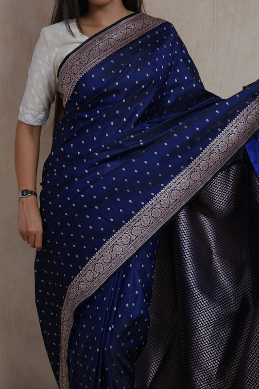 Close-up of navy blue Banarasi silk saree with silver buttas and floral woven border