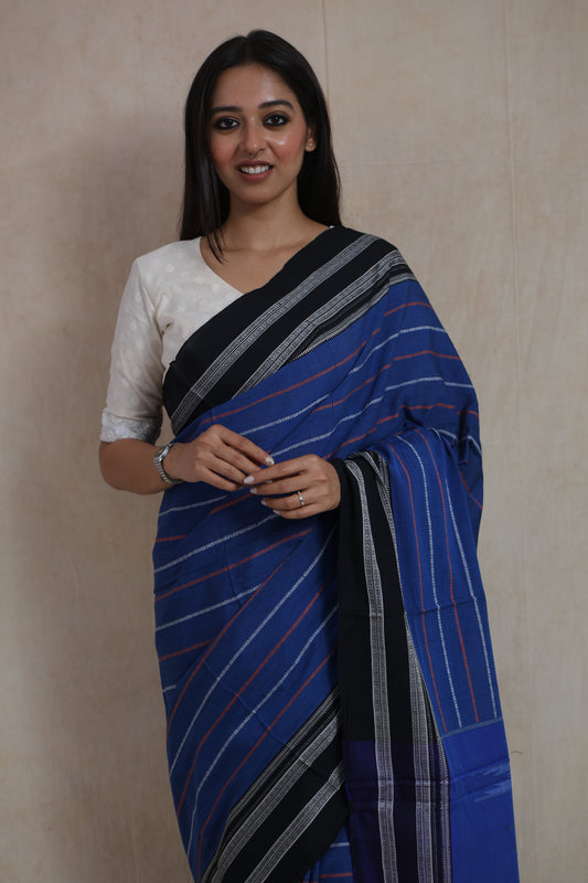 Close-up of handwoven royal blue Ilkal cotton saree with fine stripe patterns