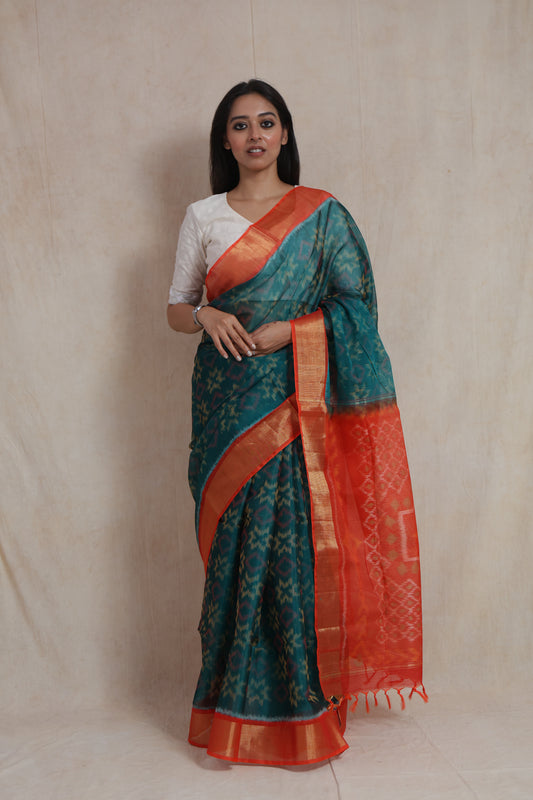 Full-length view of teal blue and vermilion orange Panchampali silk cotton saree with contrast pallu