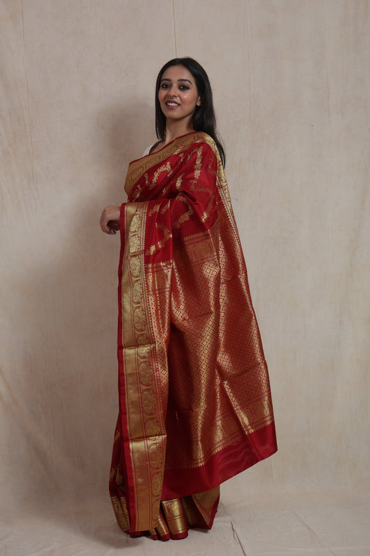 Side view of crimson Venkatgiri silk saree showcasing the richly woven pallu and elegant border