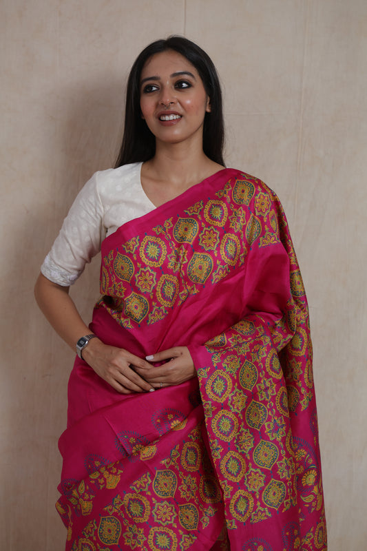 Model wearing rani pink Batik silk saree with traditional floral and paisley motifs