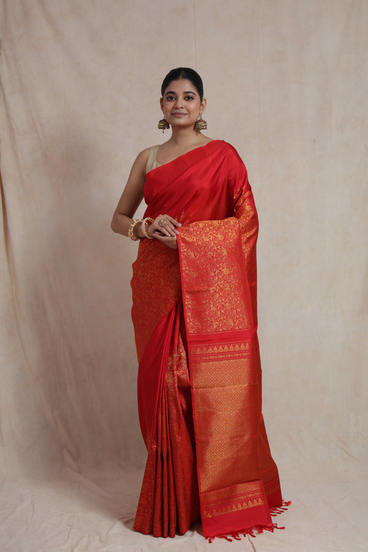 Front view of radiant red Kanjivaram silk saree with intricate woven border and rich pallu.