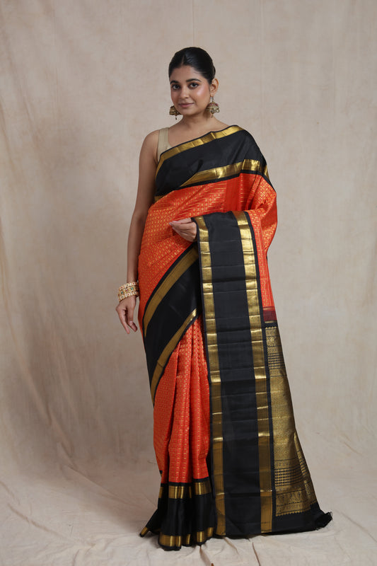 Vermilion red and black Kanjivaram pure silk saree with traditional woven motifs and contrast border