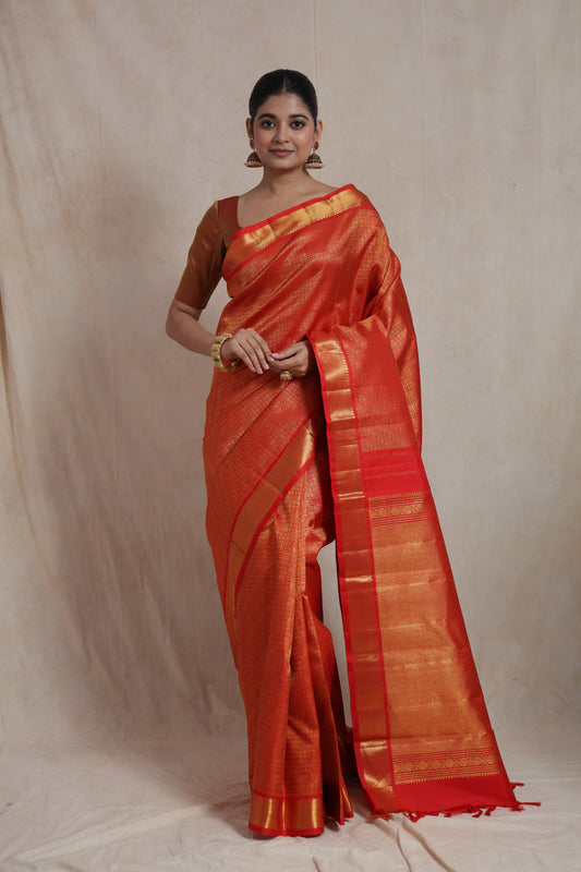 Front view of vermilion red Kanjivaram pure silk saree with intricate woven patterns and traditional border