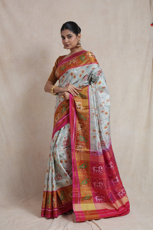 Side view of ivory Patola silk saree with vibrant woven border