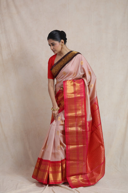 Side view of ivory beige Gadwal silk saree showcasing rich red woven border detailing