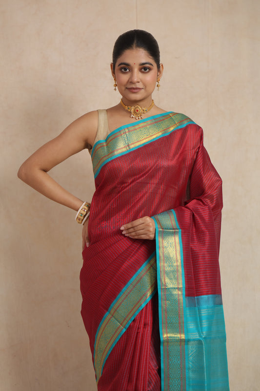 Close-up of the maroon textured body and aqua blue woven border of the Kanchipuram SICO saree