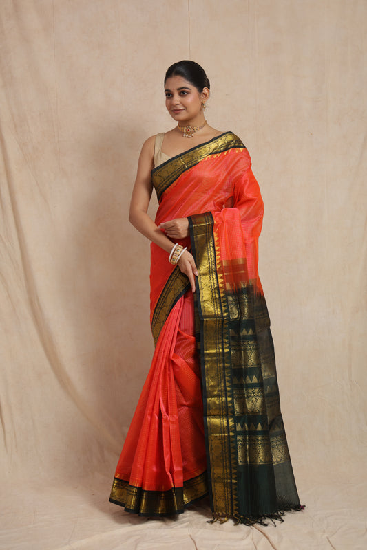 Front view of coral orange Kanchipuram Handloom SICO saree with black contrast border