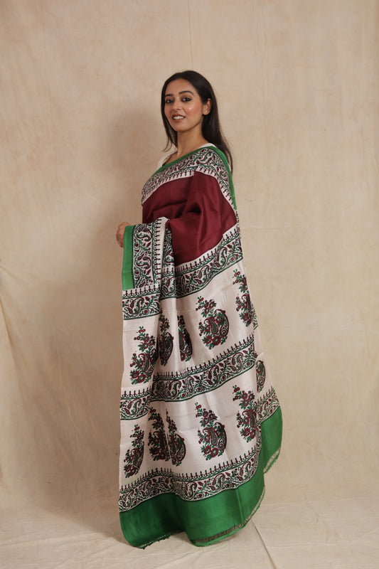 Side profile view of maroon Batik silk saree with artistic printed border