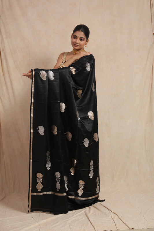 Traditional pallu display of black Banarasi silk saree with silver floral weaving