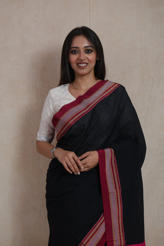 Close-up drape view of black Ilkal cotton saree with traditional border