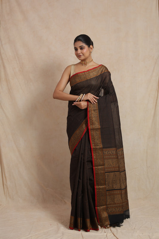 Elegant pose in black Kanchipuram cotton saree