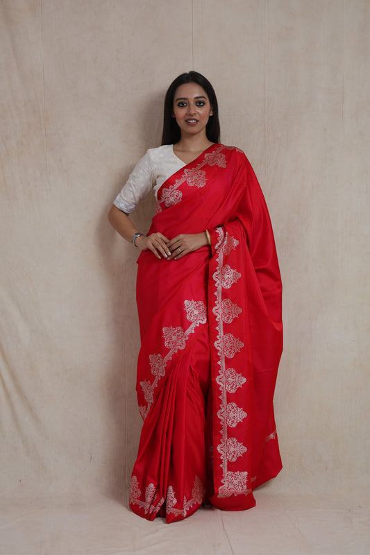 Front view of crimson red Banarasi art silk saree with elegant floral woven border