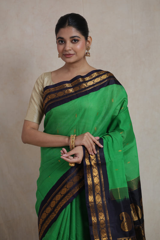 Front portrait of emerald green Gadwal Sico saree with zari woven border