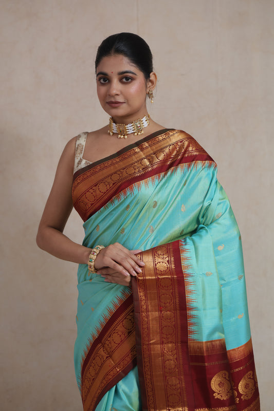 Elegant mint green Gadwal silk saree with traditional zari border