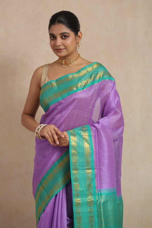 Lavender Kanchipuram Sico saree with aqua green zari border, detailed close-up showcasing intricate weaving and rich fabric.