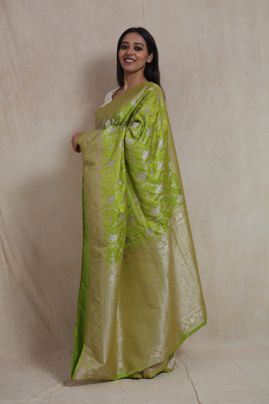 Side view of lime green Banarasi art silk saree with floral woven motifs and rich border