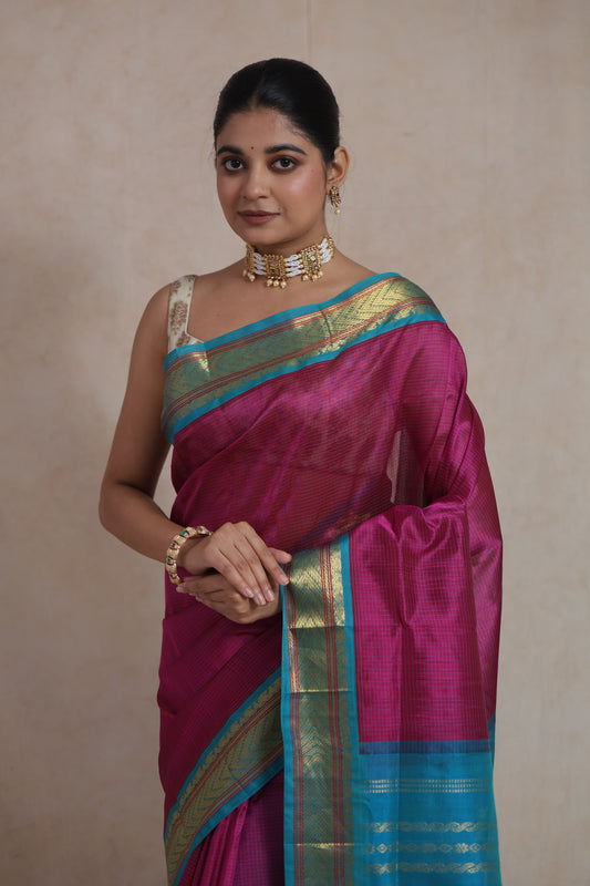Portrait view of magenta Kanchipuram silk cotton saree with aqua blue zari border