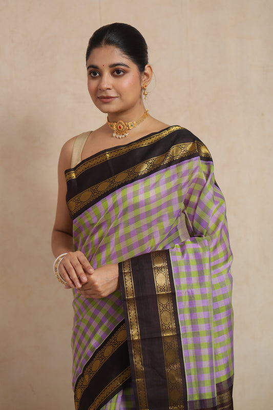 Portrait view of lavender and olive checked Kanchipuram Sico saree with rich zari border