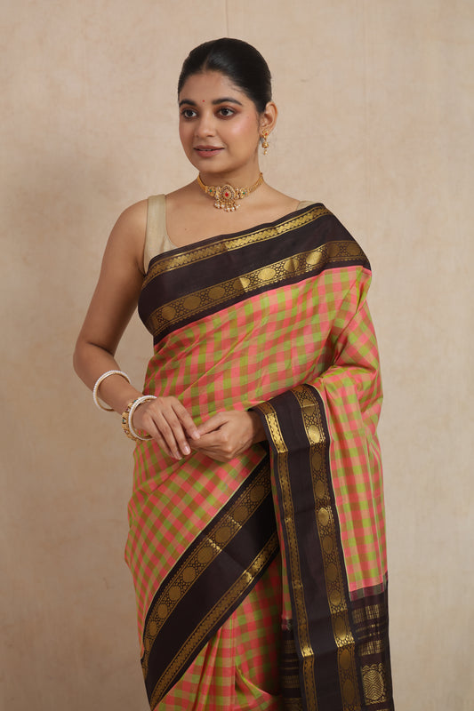 Front look of pastel pink checked Kanchipuram Sico saree with traditional woven border