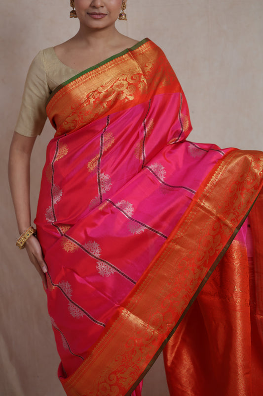Close-up of rani pink Gadwal SICO saree with woven motifs and rich border