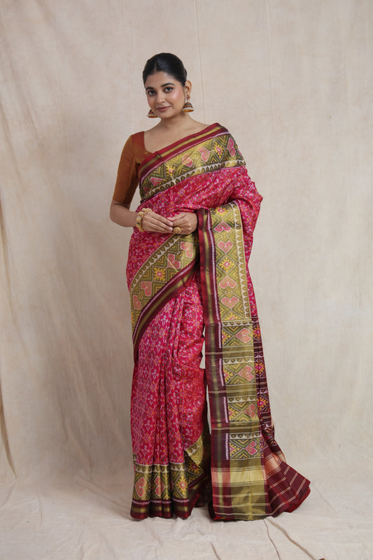 Full-length drape of elegant rani pink Patola silk saree
