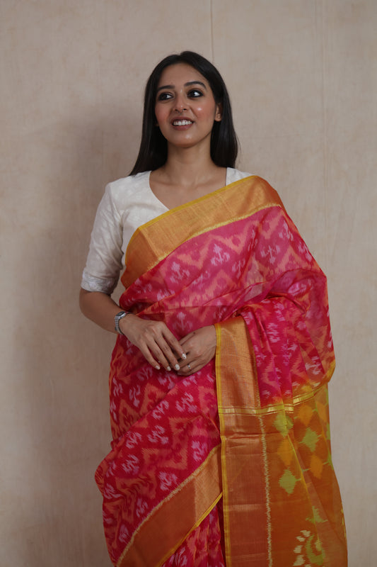 Elegant Rani pink Pochampally silk cotton saree with golden zari border and woven motifs