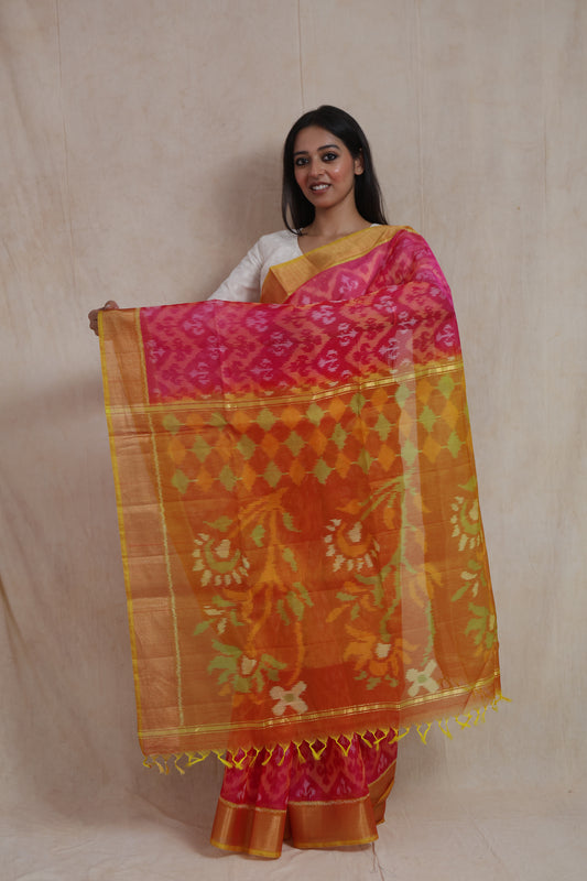 Rani pink Pochampally silk cotton saree with orange floral woven pallu and zari border