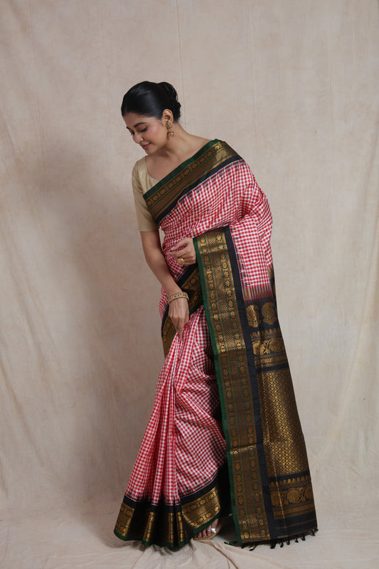 Rich woven pallu view of red checked Gadwal Silk saree with black gold zari border