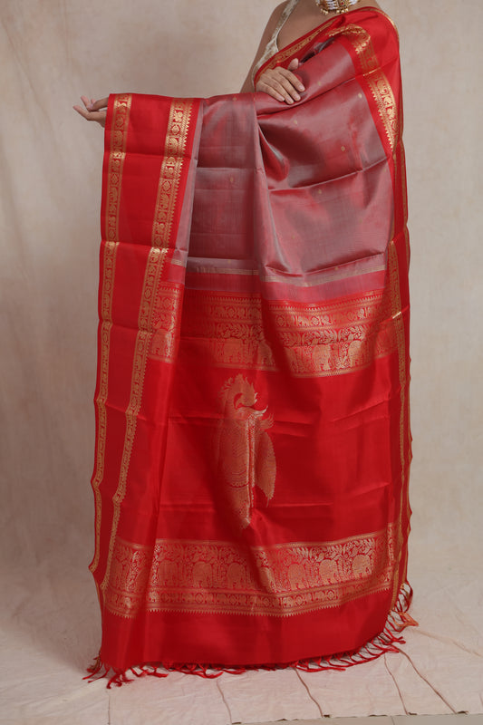 Model showcasing richly woven pallu of red Kanchiwaram silk saree
