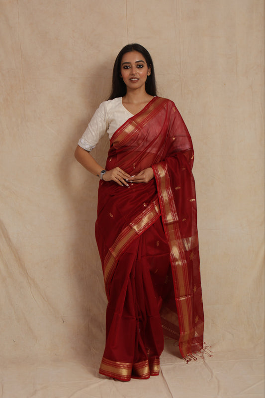 Full drape look of ruby red Maheshwari silk cotton saree with golden woven border