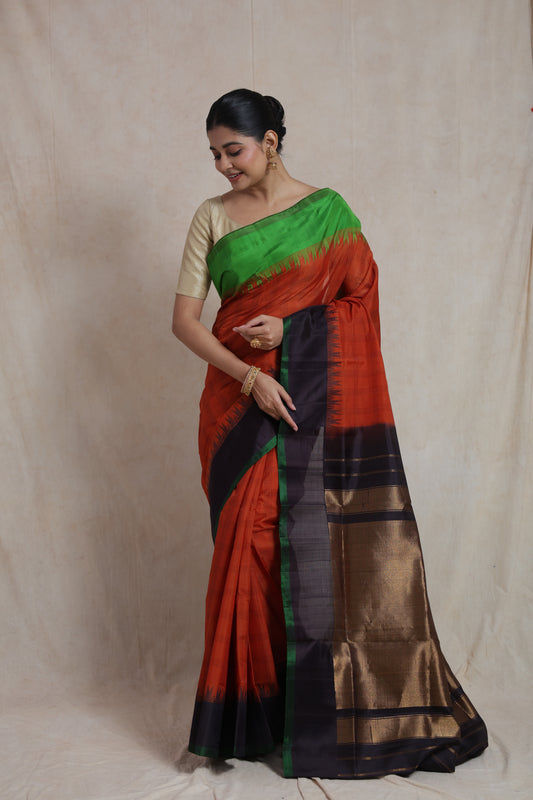 Elegant pose in rust orange Gadwal Sico saree with traditional woven pallu