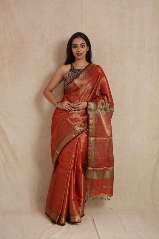Front view of rust orange Maheshwari tissue saree with zari border