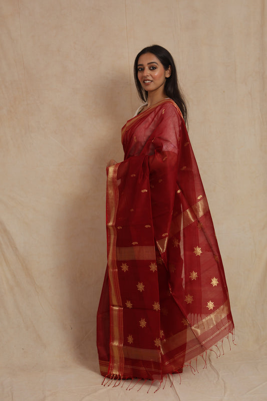 Side profile of ruby red Maheshwari handloom silk cotton saree with tassel pallu