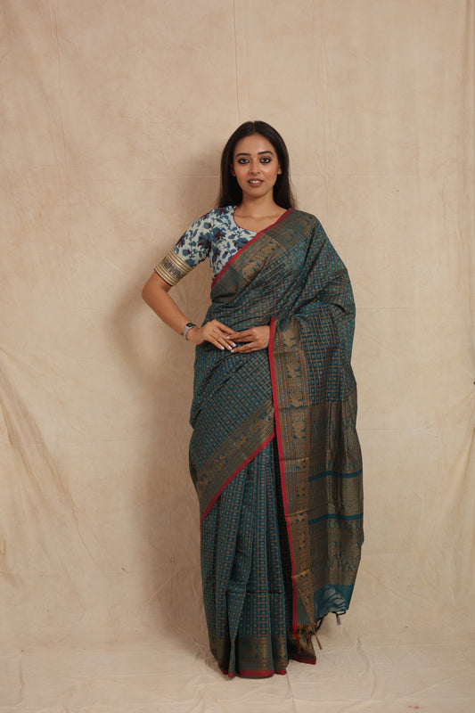 Model wearing teal blue Kanchipuram cotton saree with gold zari checks and contrast pink border front view