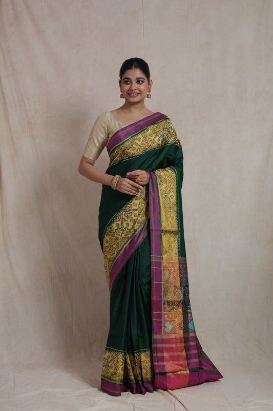 Front view of emerald green Patola silk saree with heritage-inspired motifs