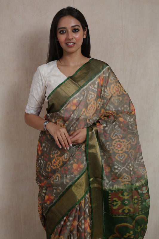 Full-length view of traditional Panchampali handloom silk cotton saree in taupe grey and emerald green combination with tassels
