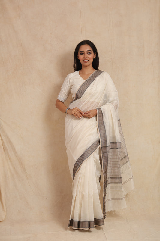 Full-length portrait of ivory Maheshwari silk tissue saree with striped pallu
