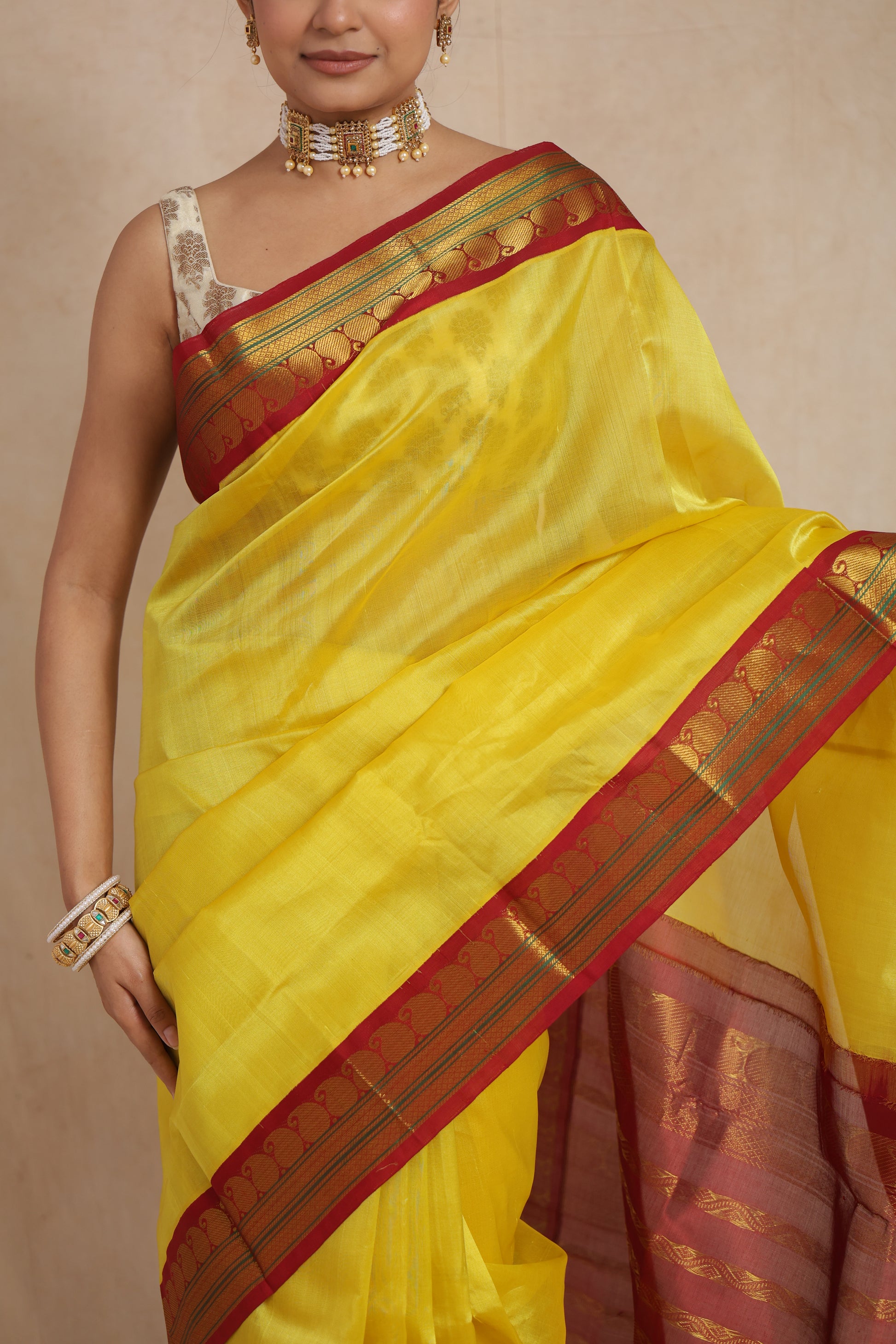 Close-up of the yellow Gadwal Silk Saree with woven maroon border
