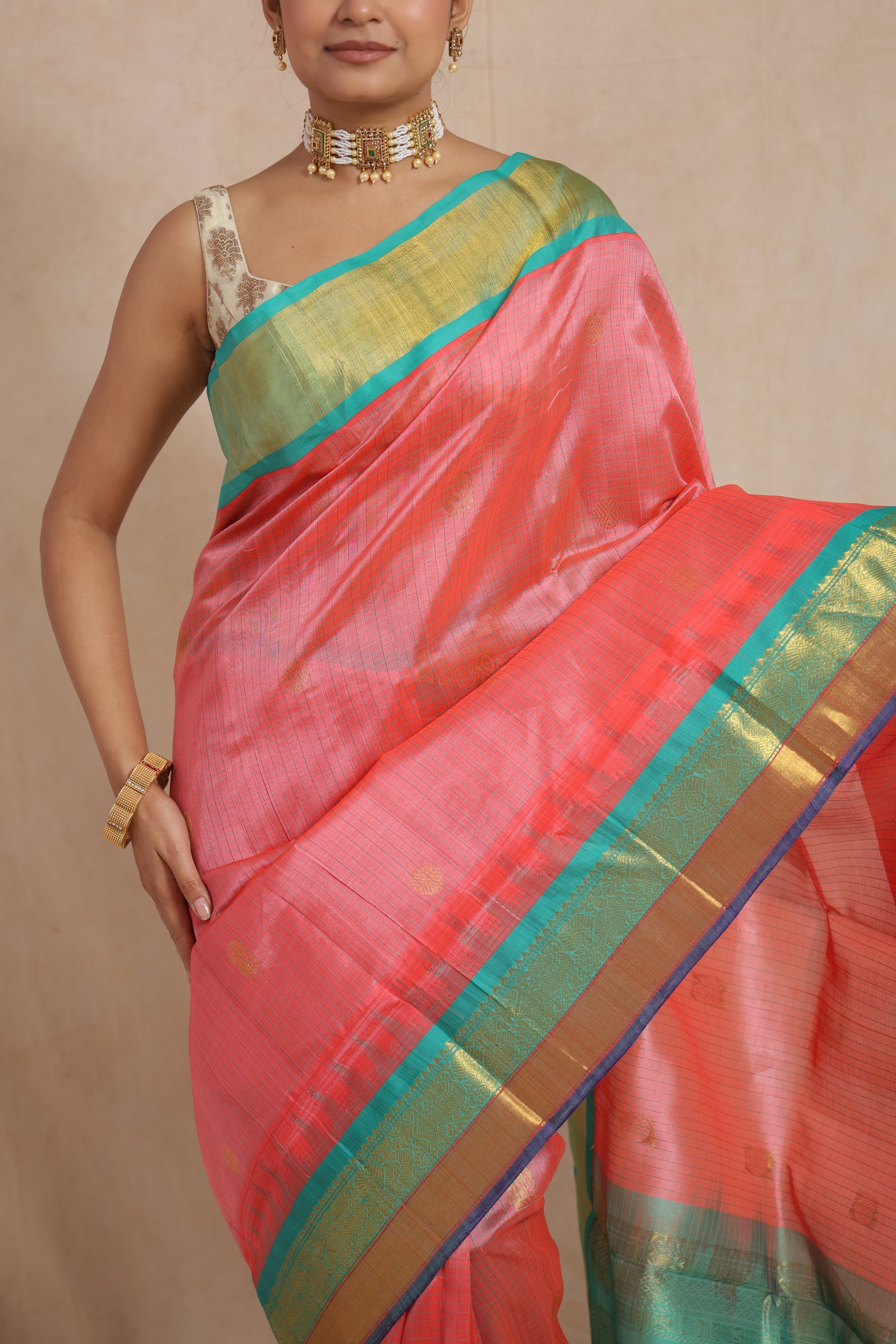 Close-up of woven motifs and contrasting aqua green border on handloom SICO saree
