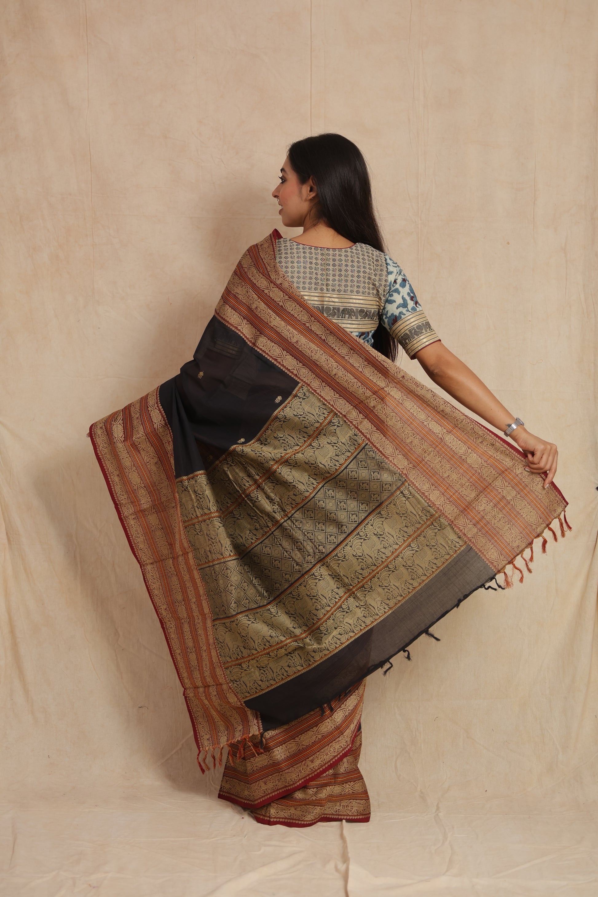 Back view displaying the richly woven pallu of a black Kanchipuram handloom cotton saree