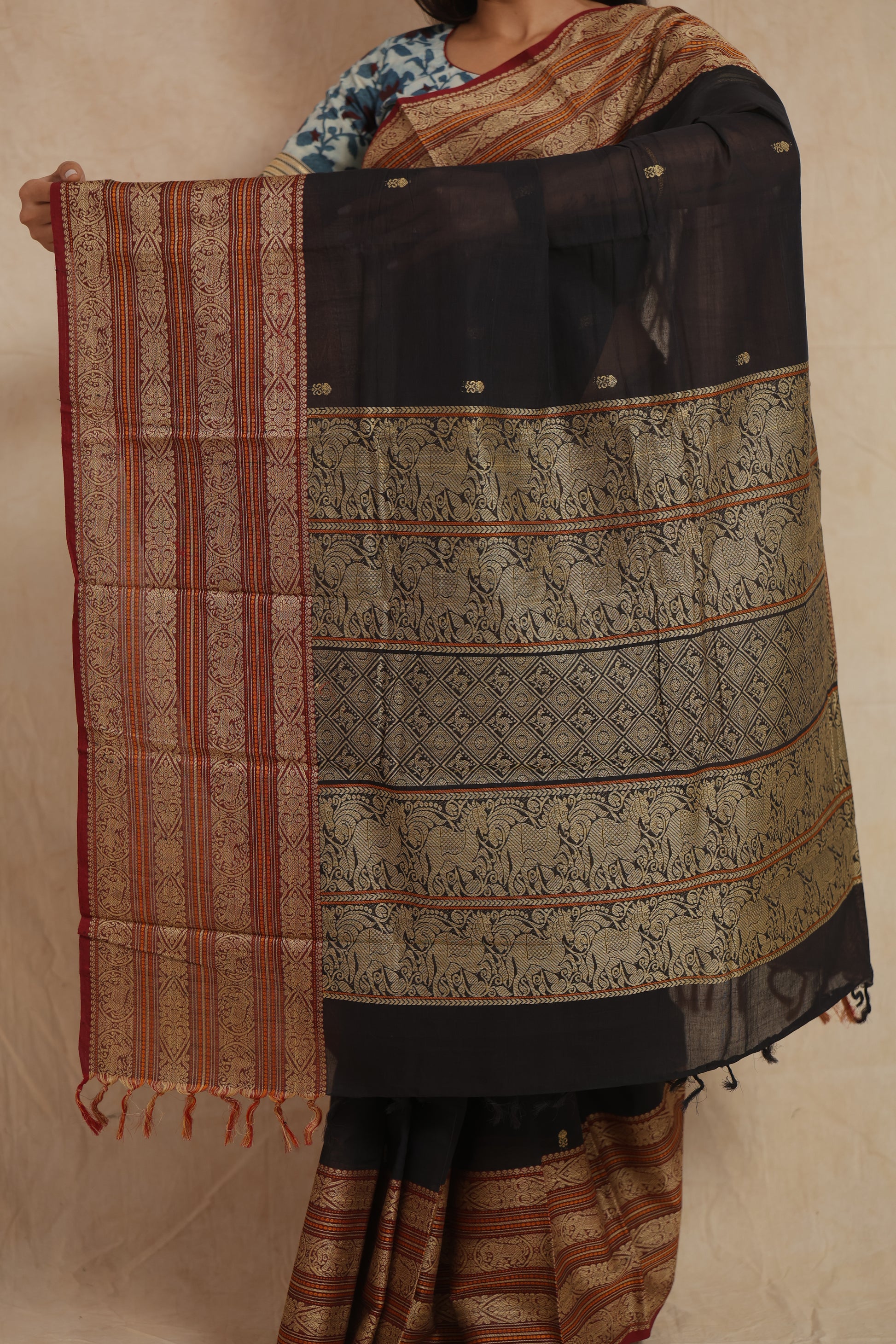 Close-up of traditional woven pallu and border on black Kanchipuram cotton saree