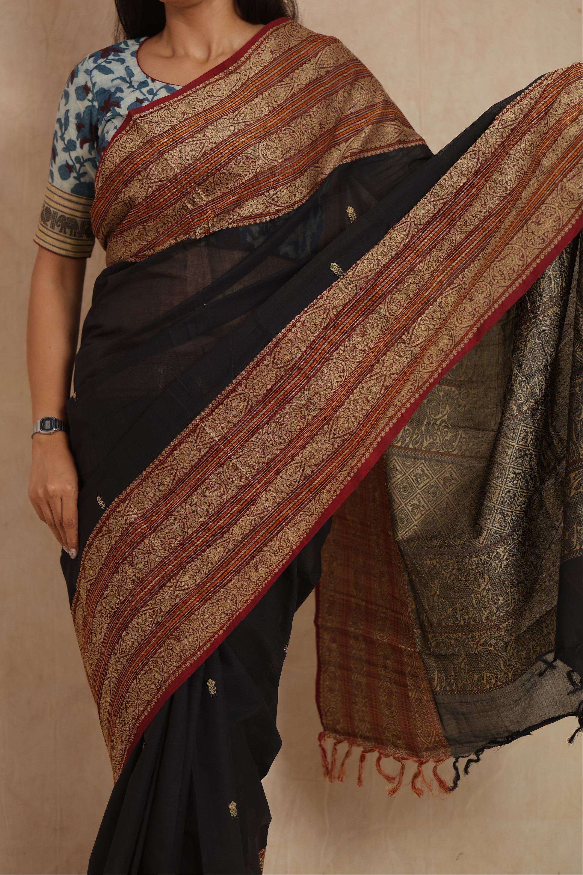 Detailed view of intricate woven border motifs on black Kanchipuram handloom cotton saree