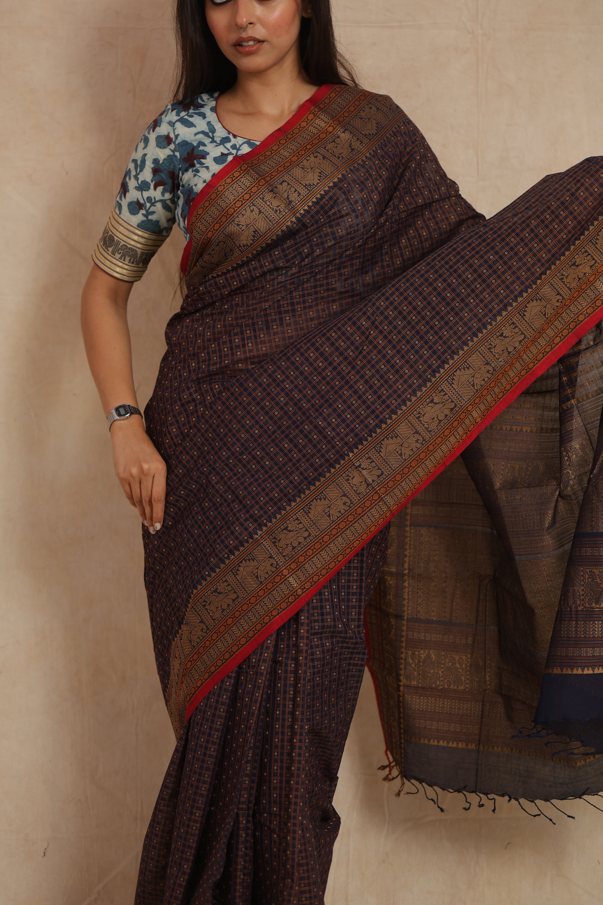Close-up of traditional woven motifs on midnight blue Kanchipuram cotton saree