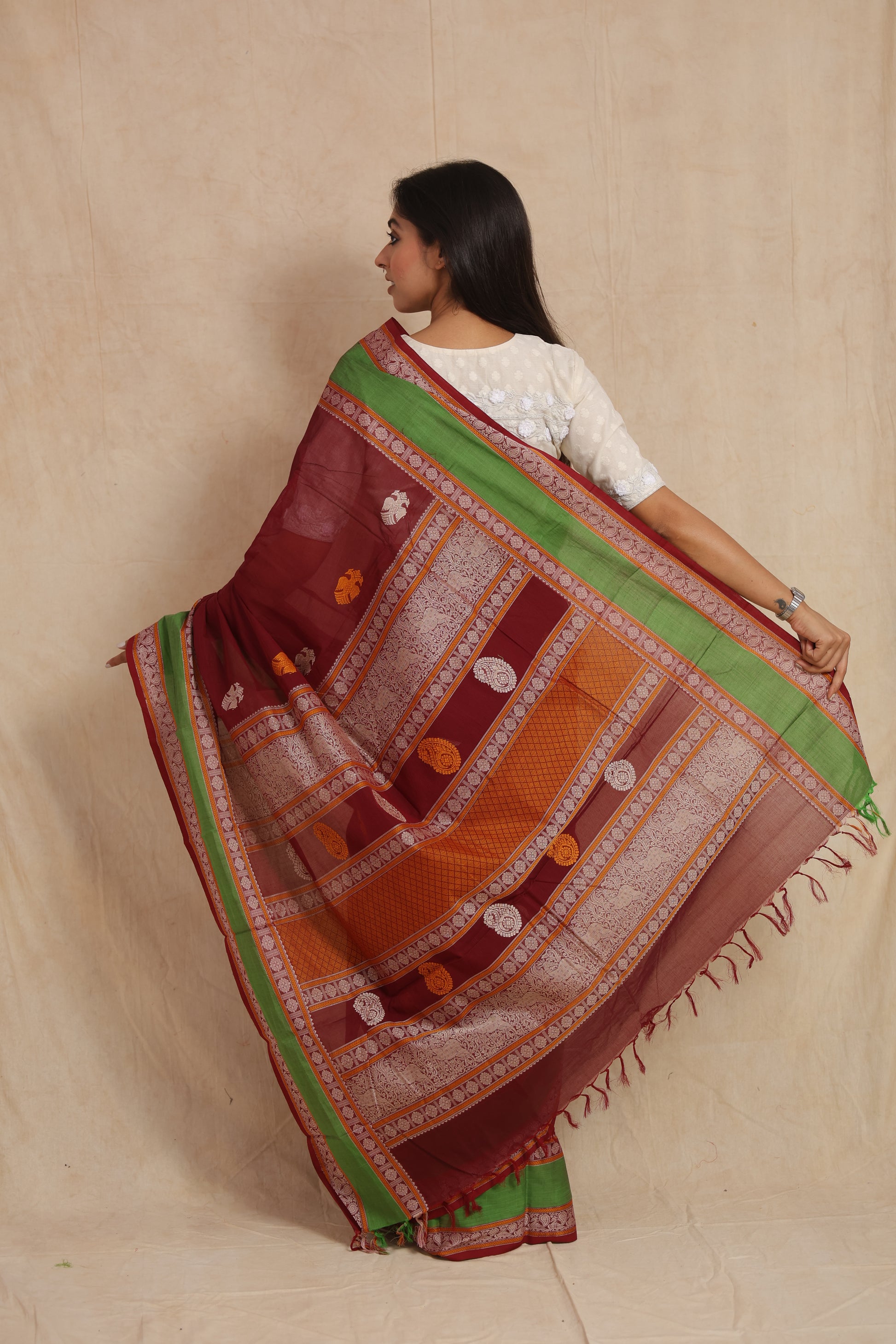 Back view highlighting the intricately woven pallu of maroon Kanchipuram cotton saree