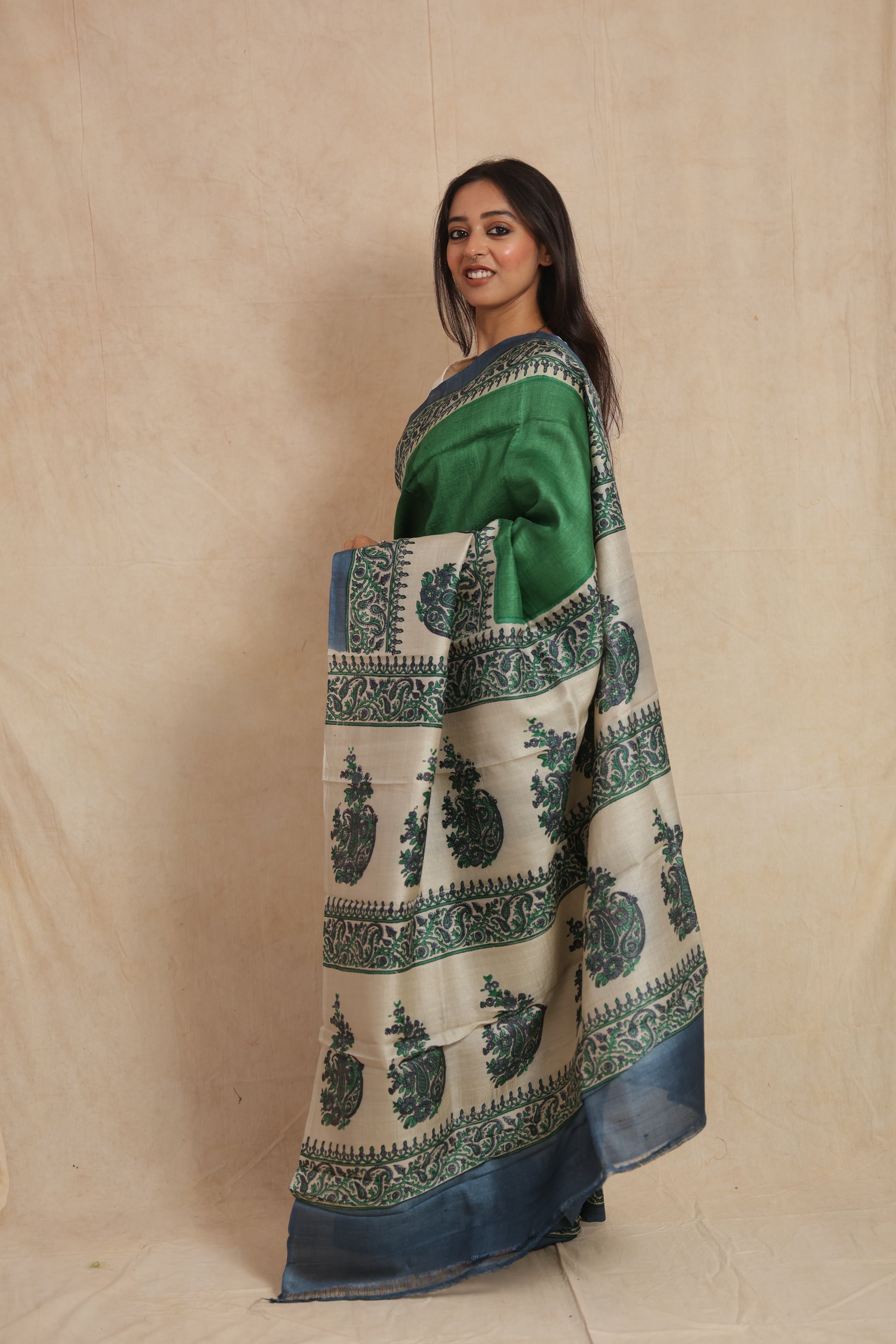 Side profile of green Tussar silk saree featuring intricate paisley and floral prints